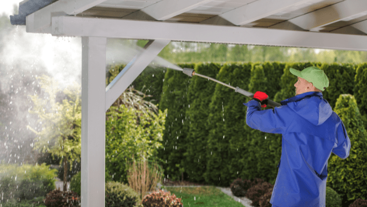 a professional cleaning us a porch with a pressure machine